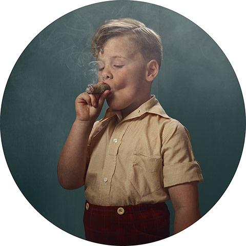 young boy with blond hair smoking